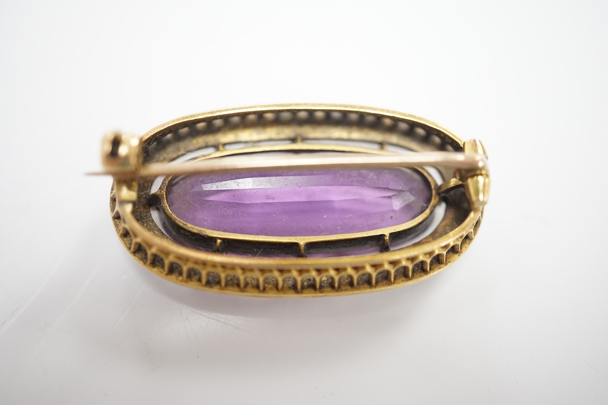 An early 20th century yellow metal mounted amethyst and split pearl cluster set oval brooch, 32mm, gross weight 8.8 grams. Condition - fair to good